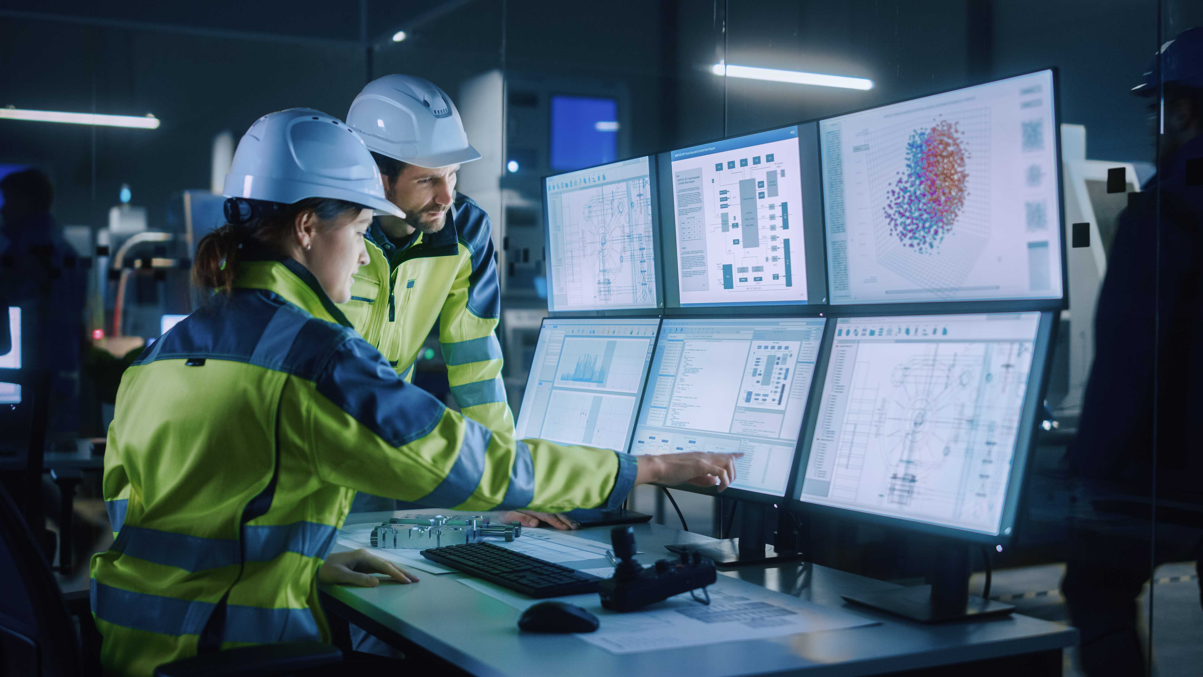 workers looking at information at a advanced operator work station